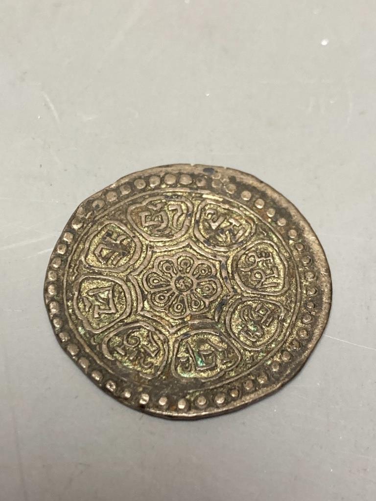 A Tibetan metal incense holder, length 33.5cm, and a Tibetan coin